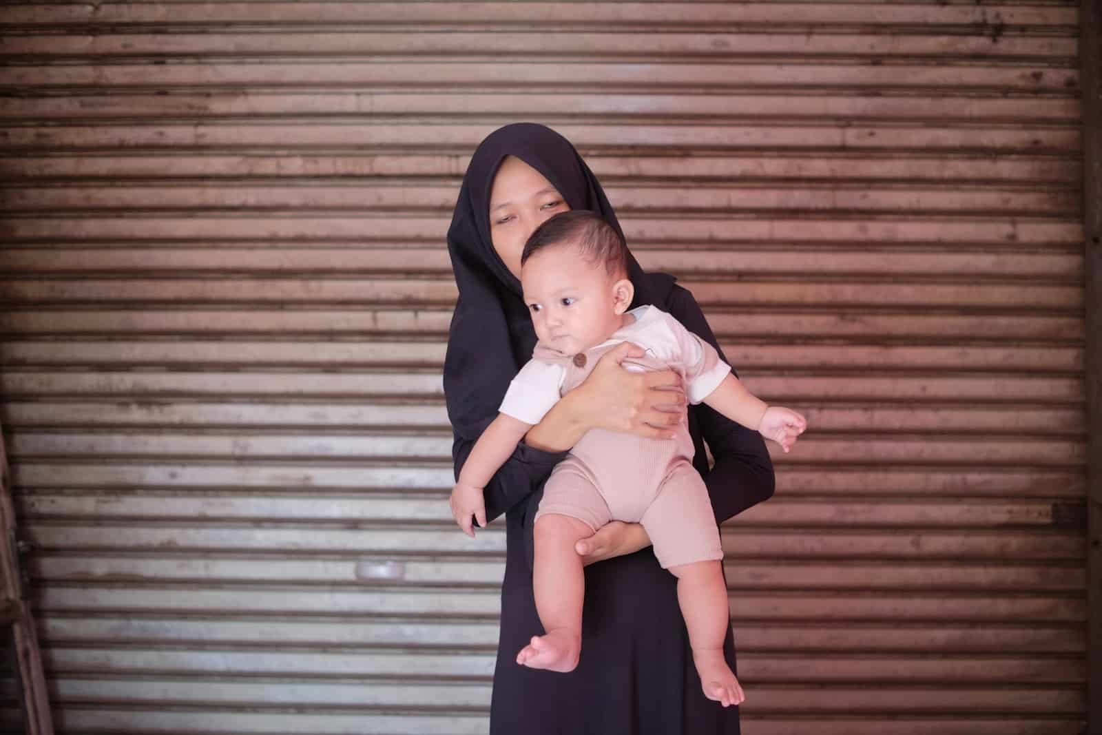 a nun holding a baby in her arms