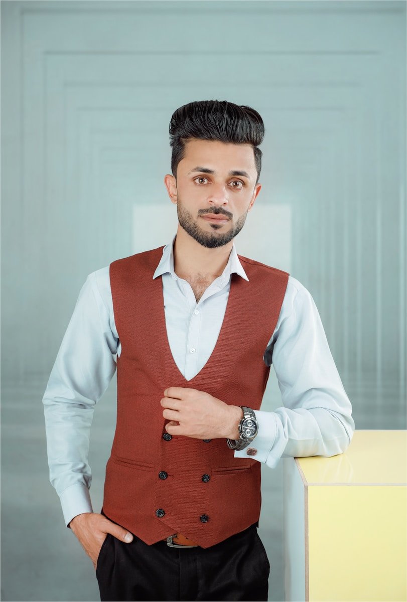 a man in a red vest and white shirt