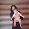 a nun holding a baby in her arms