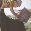 woman holding boy during daytime